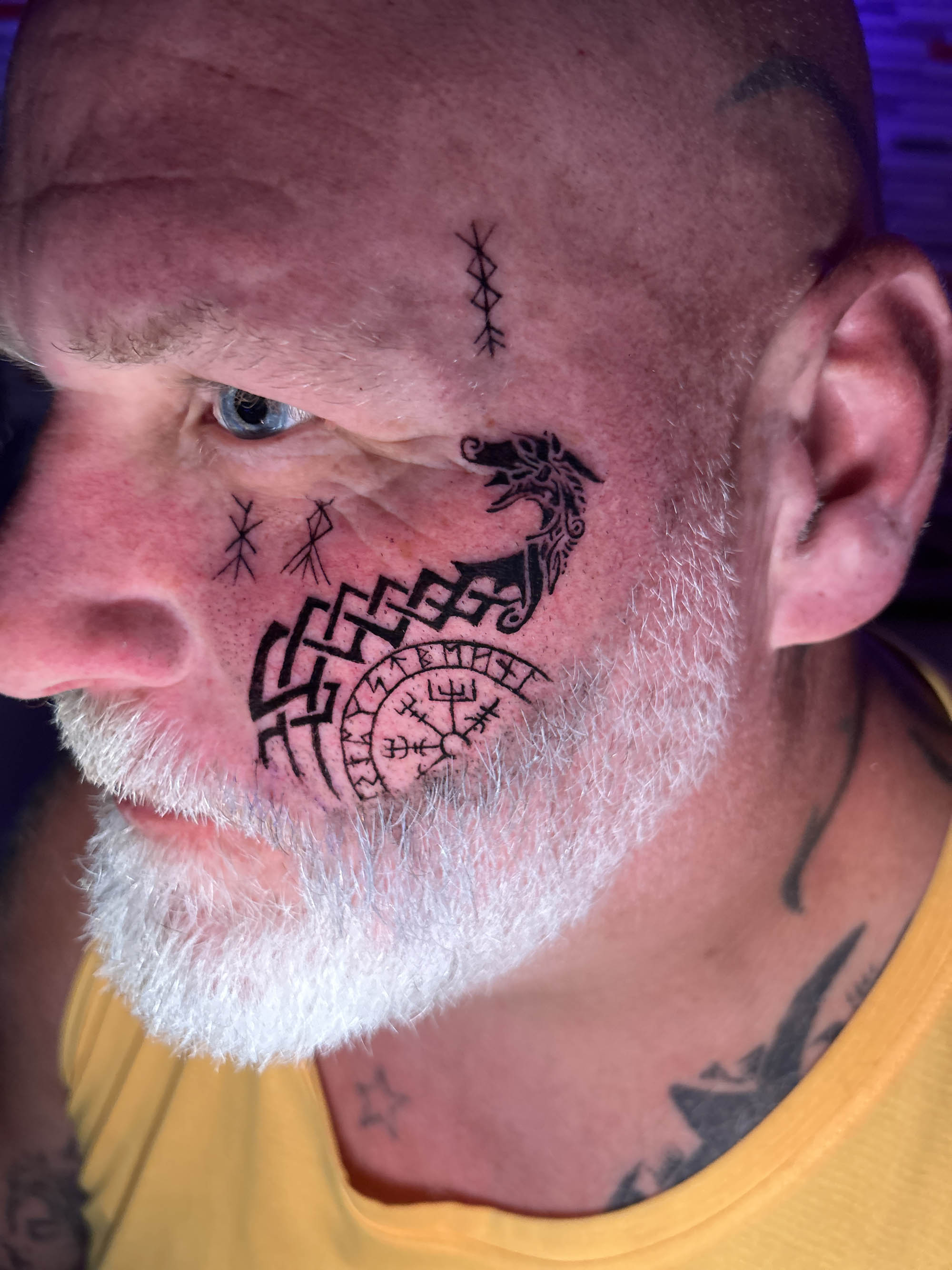 Viking symbols and runes on face